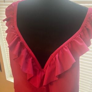 Never worn plus size one piece swimsuit. It has ruffles & crisscross in the back